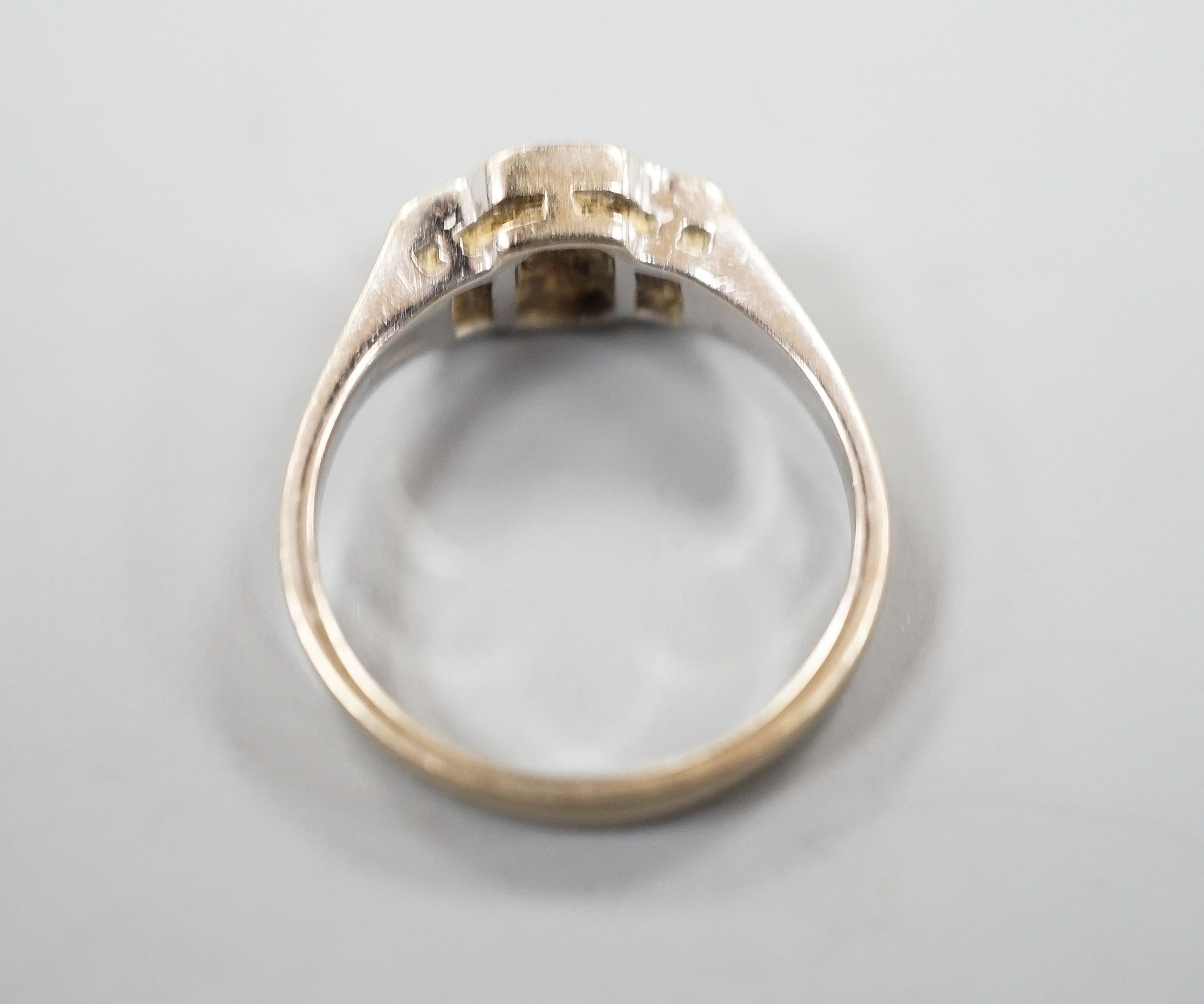 A modern 18ct white gold, collet set sapphire and diamond three stone ring, size L, gross weight 3.8 grams.